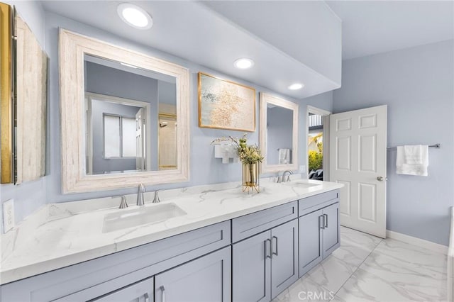 bathroom with recessed lighting, marble finish floor, a sink, and baseboards