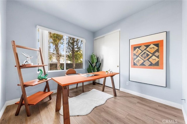 office space featuring baseboards and wood finished floors