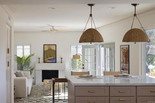 kitchen featuring visible vents, ornamental molding, open floor plan, gray cabinetry, and a fireplace