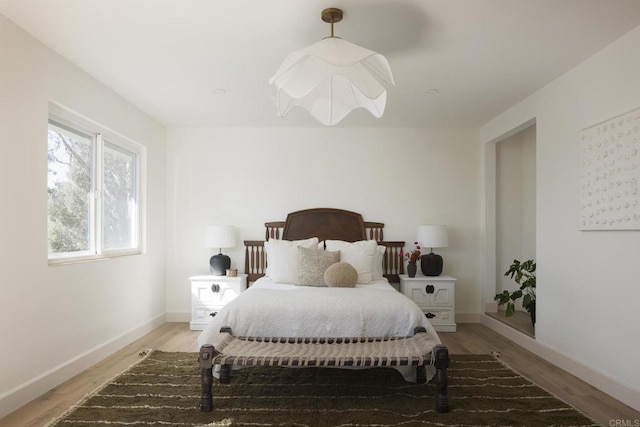 bedroom featuring baseboards and light wood-style floors