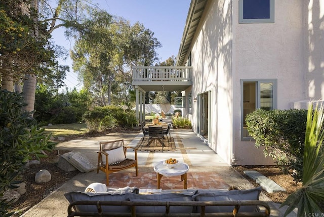 view of patio / terrace with outdoor dining space and a balcony