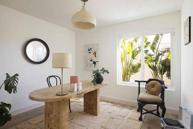 office area with light wood finished floors and baseboards