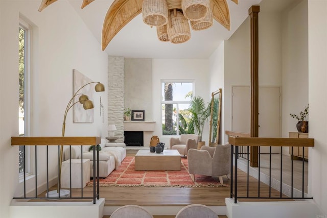 living room featuring a healthy amount of sunlight, a fireplace, and wood finished floors