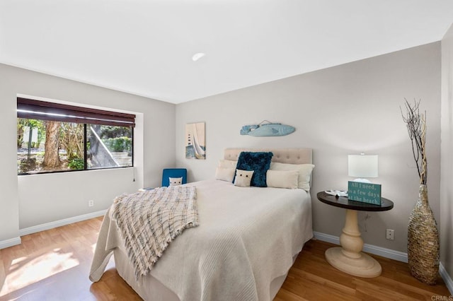 bedroom with wood finished floors and baseboards