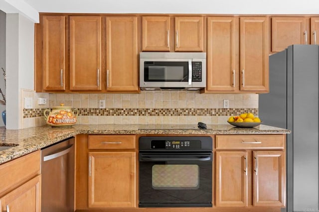 kitchen with light stone counters, backsplash, and black appliances