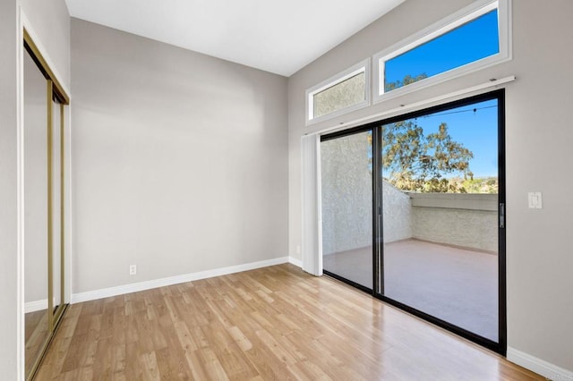 unfurnished room featuring baseboards and wood finished floors