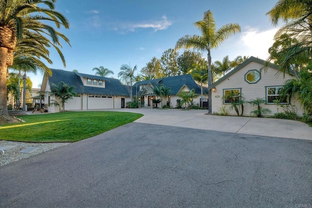 view of front of home with driveway and a front lawn