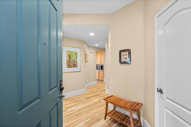 foyer with light wood-type flooring, baseboards, and recessed lighting