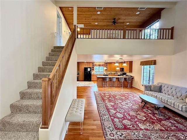 living room with wooden ceiling, plenty of natural light, and light wood finished floors