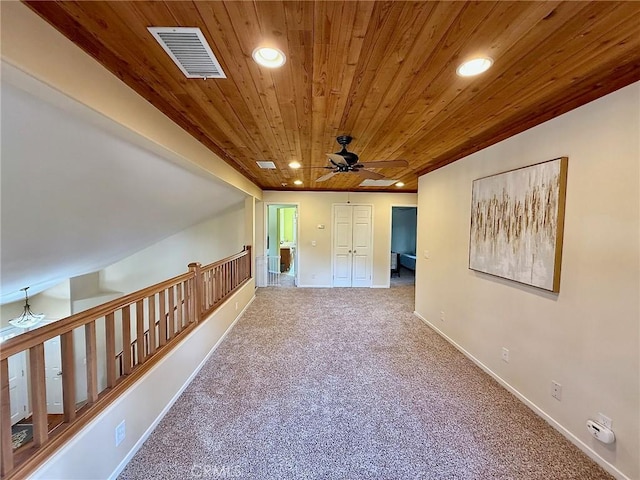 interior space featuring carpet floors, wood ceiling, visible vents, and recessed lighting