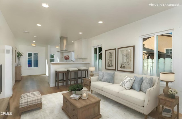 living room featuring light wood-style flooring and recessed lighting