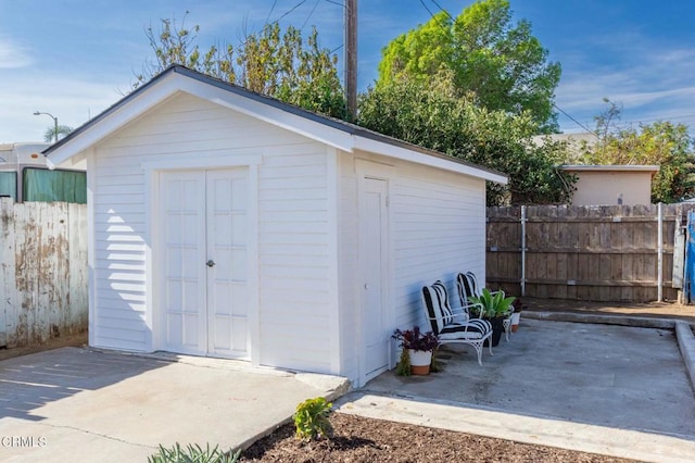 view of shed with fence