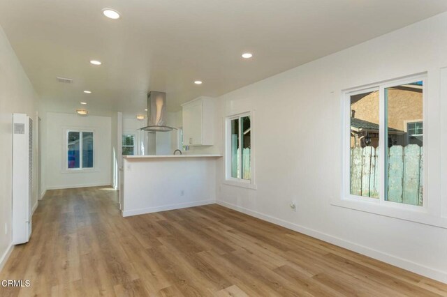 238 Stanford St, Santa Paula, CA 93060 - unfurnished living room featuring a heating unit, light wood-style flooring, and recessed lighting