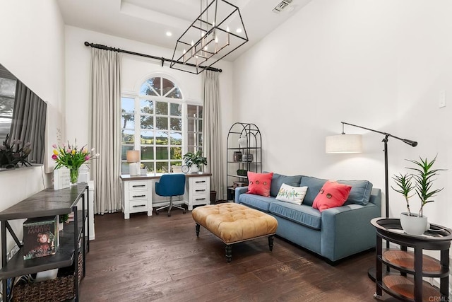 sitting room with recessed lighting, visible vents, a high ceiling, an inviting chandelier, and wood finished floors