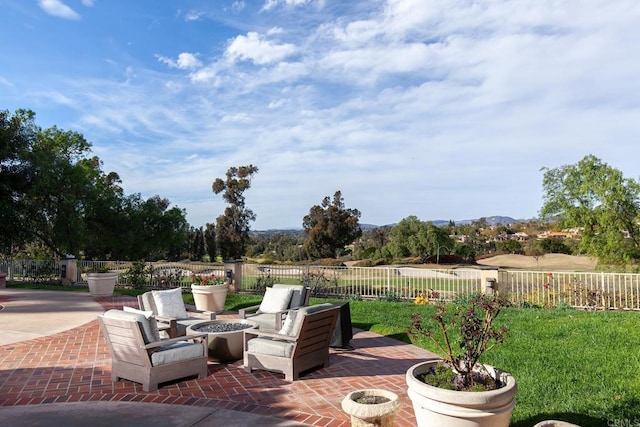 view of patio / terrace featuring fence and a fire pit