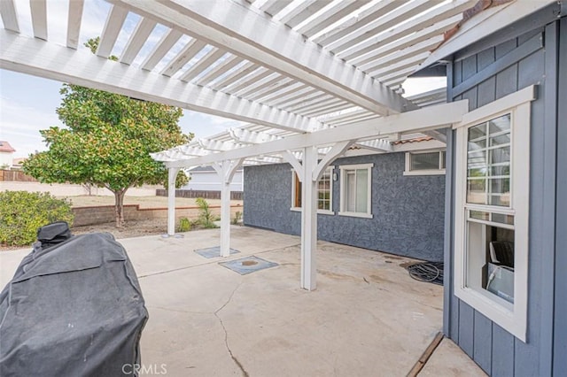 view of patio with area for grilling, fence, and a pergola