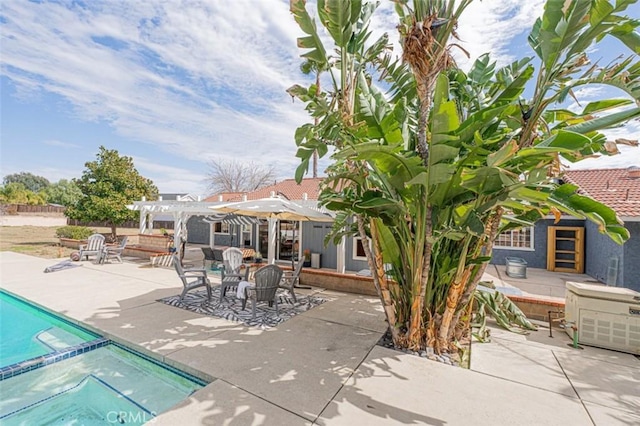 view of patio / terrace featuring a pool with connected hot tub and a pergola