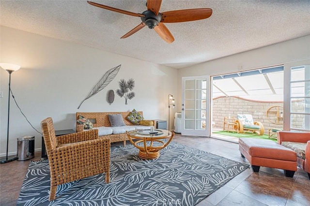 living area with a ceiling fan, a healthy amount of sunlight, and a textured ceiling