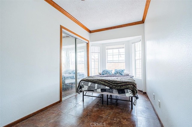 bedroom featuring a textured ceiling, a textured wall, baseboards, and crown molding