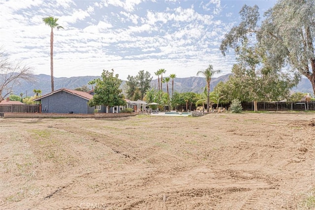 view of yard with fence and a mountain view