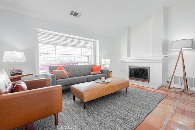 living room with a fireplace, lofted ceiling, visible vents, ornamental molding, and tile patterned flooring