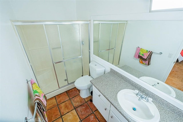 full bath featuring toilet, a stall shower, a baseboard heating unit, and vanity