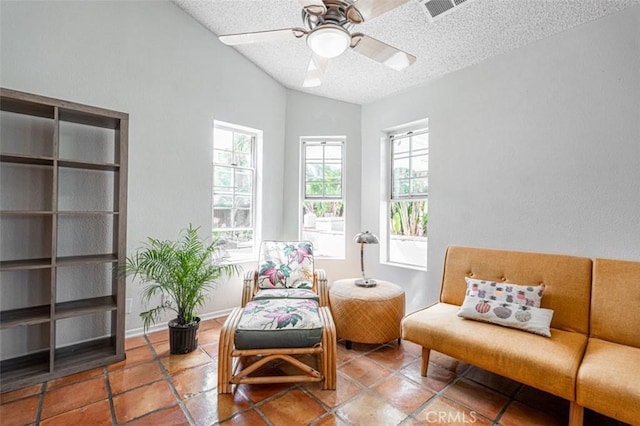 sitting room featuring visible vents, vaulted ceiling, ceiling fan, a textured ceiling, and baseboards