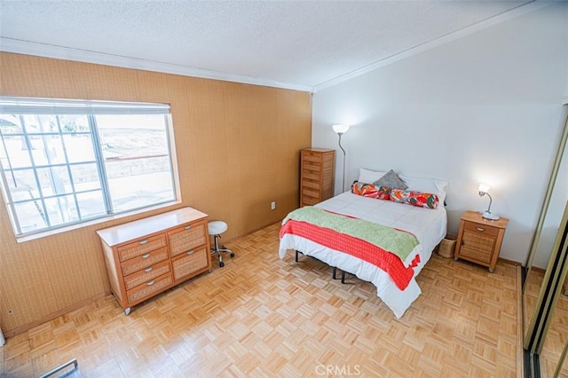 bedroom featuring crown molding and a textured ceiling