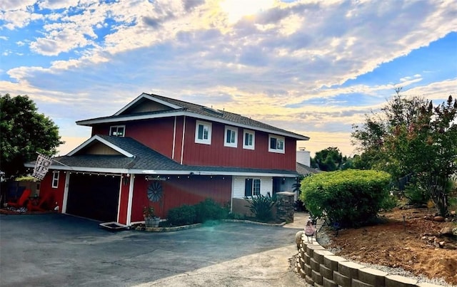 traditional home with aphalt driveway and a garage