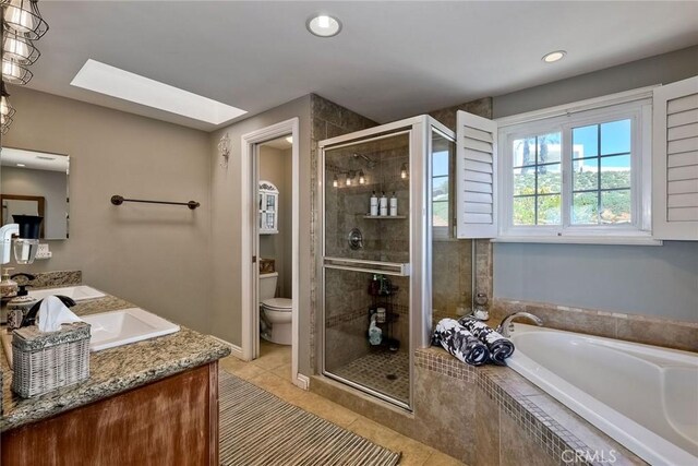 2056 Wonderview Dr, Vista, CA 92084 - bathroom with a garden tub, a shower stall, vanity, tile patterned flooring, and a skylight