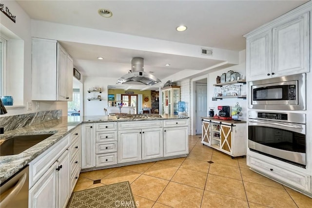 2056 Wonderview Dr, Vista, CA 92084 - kitchen featuring stainless steel appliances, a peninsula, light tile patterned floors, white cabinetry, and recessed lighting