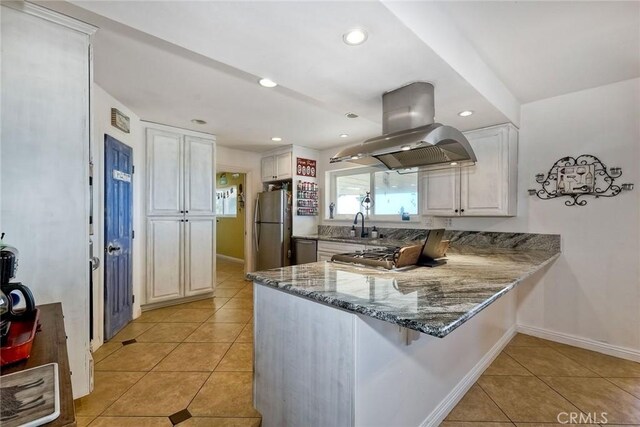 2056 Wonderview Dr, Vista, CA 92084 - kitchen with island exhaust hood, light tile patterned flooring, stainless steel appliances, a peninsula, and stone counters
