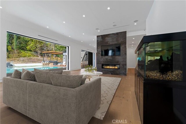 4653 Vanalden Ave, Tarzana, CA 91356 - living room with a large fireplace, light wood-style floors, and recessed lighting