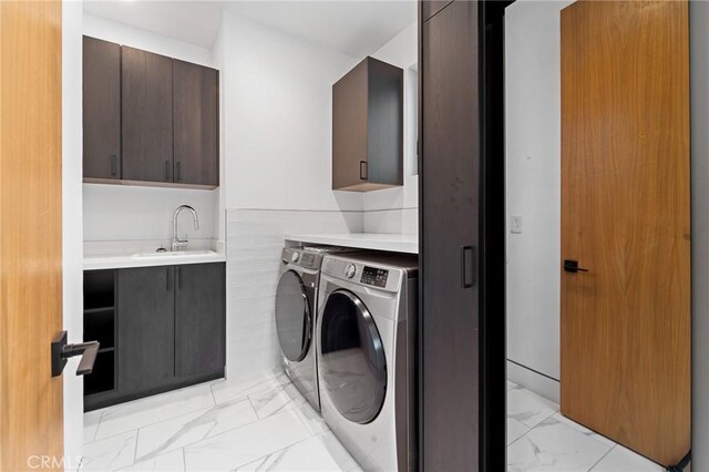 4653 Vanalden Ave, Tarzana, CA 91356 - laundry area featuring cabinet space, light marble finish floors, washing machine and dryer, and wet bar