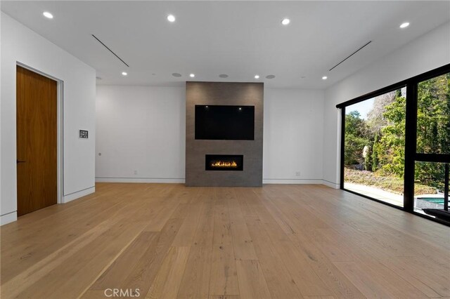 4653 Vanalden Ave, Tarzana, CA 91356 - unfurnished living room featuring light wood-style flooring, recessed lighting, a large fireplace, and baseboards