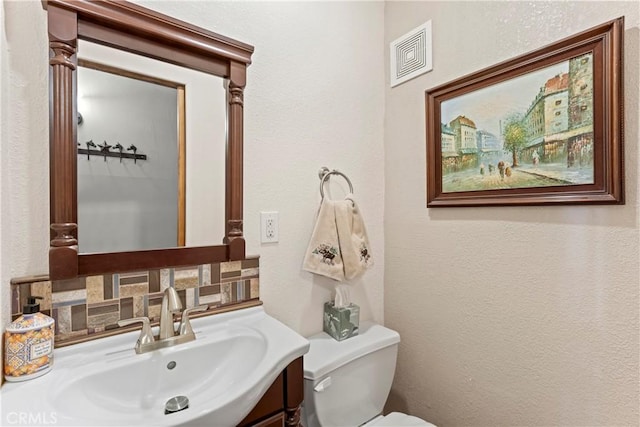 750 Zurich Dr, Lake Arrowhead, CA 92352 - bathroom with toilet, a textured wall, visible vents, and vanity