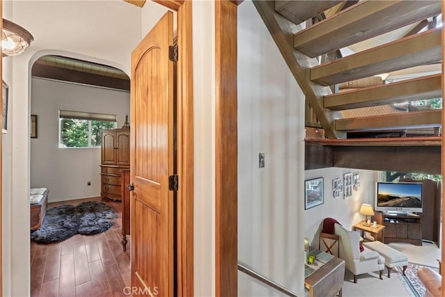 750 Zurich Dr, Lake Arrowhead, CA 92352 - hallway with baseboards, arched walkways, stairs, and wood finished floors