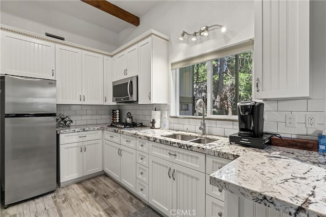 750 Zurich Dr, Lake Arrowhead, CA 92352 - kitchen featuring stainless steel appliances, light stone countertops, decorative backsplash, and a sink
