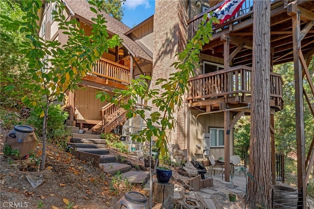 750 Zurich Dr, Lake Arrowhead, CA 92352 - back of property featuring roof with shingles, stairs, a chimney, and a balcony