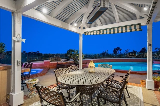 view of patio / terrace featuring a gazebo, outdoor dining area, and an outdoor pool