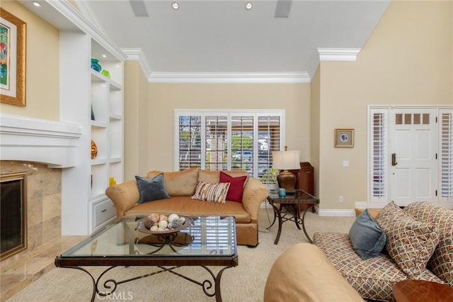 carpeted living room featuring built in shelves, recessed lighting, baseboards, ornamental molding, and a tiled fireplace