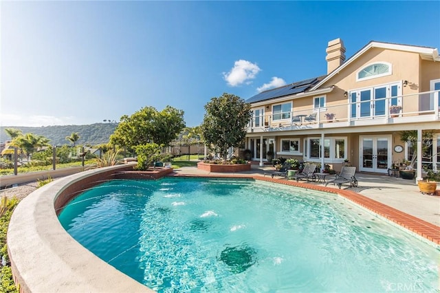 view of swimming pool with a fenced in pool, french doors, and a patio