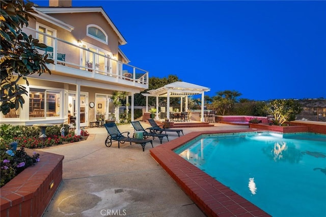 outdoor pool featuring a pergola and a patio