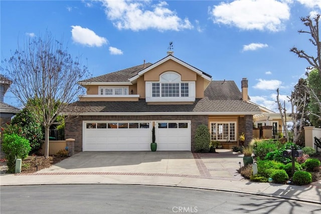 traditional home with a garage, concrete driveway, fence, and stucco siding