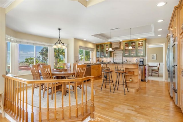 dining room with recessed lighting, a raised ceiling, visible vents, and light wood-style floors