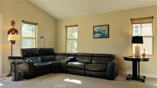 living room with lofted ceiling, carpet floors, baseboards, and a healthy amount of sunlight