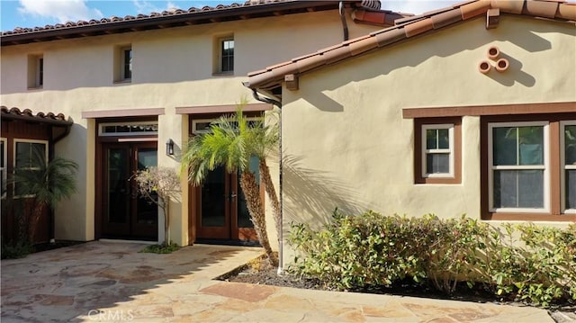 property entrance with stucco siding