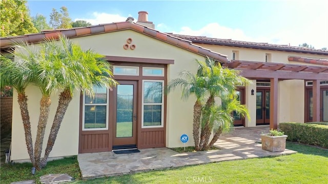 exterior space featuring stucco siding and a pergola