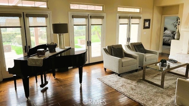 living area with dark wood-style floors and french doors