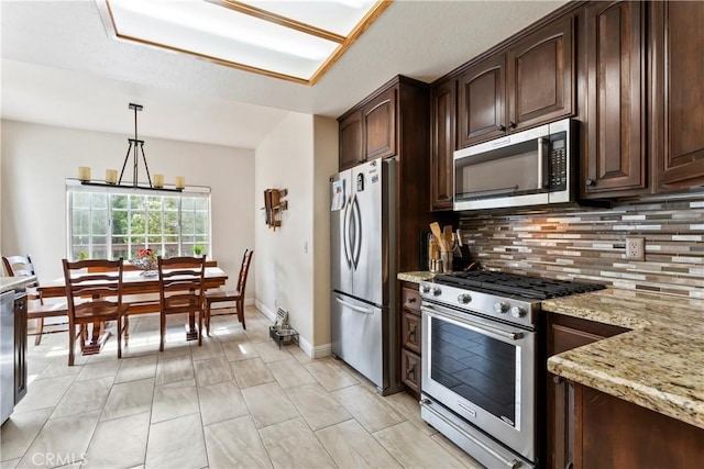 892 Breithorn Dr, Lake Arrowhead, CA 92352 - kitchen featuring light stone countertops, appliances with stainless steel finishes, dark brown cabinetry, and tasteful backsplash
